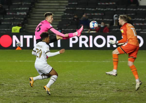 Flynn Clarke of Peterborough United challenges for the ball at MK Dons. Photo: Joe Dent/theposh.com/