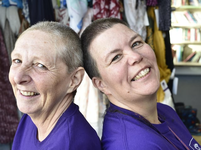 Sue Reeves (dark hair) and Debbie Gibbs (light hair) from the East Anglian Childrens' Hospice charity shop , Whittlesey taking part in a charity head shave. EMN-201217-144309009