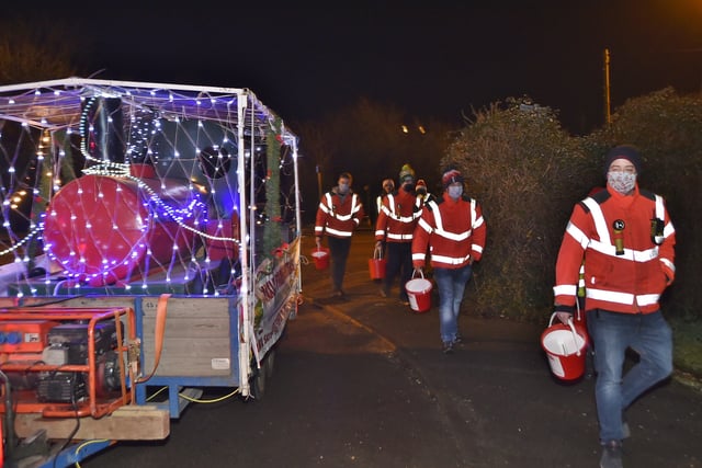Firefighters and volunteers meeting residents of Yaxley as their Christmas sleigh tours the village EMN-201215-204755009