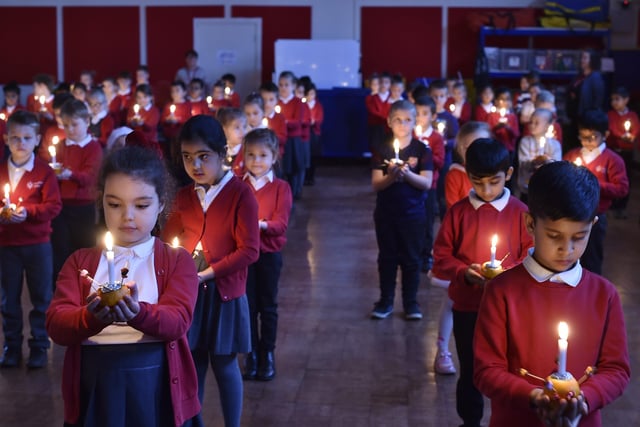Year 2 pupils at Dogsthorpe Infants School taking part in their Christmas Christingle service.