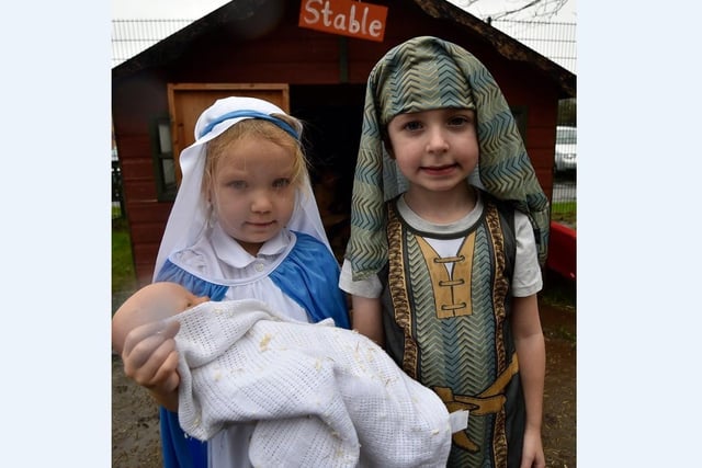 Mary and Joseph outside the stable with the baby Jesus.