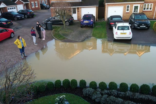 Resdidents look at the devastation caused by the floods
