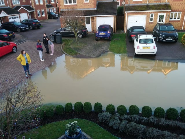 Resdidents look at the devastation caused by the floods