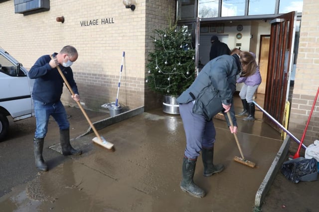 Volunteers at Brigstock Village Hall this morning trying to clear the water away