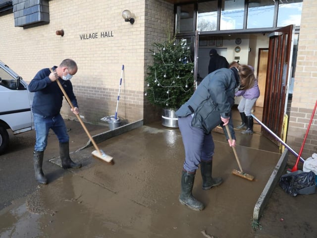Volunteers at Brigstock Village Hall this morning trying to clear the water away