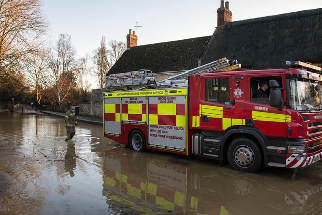 A firefighter wades through the flood water in Warkton