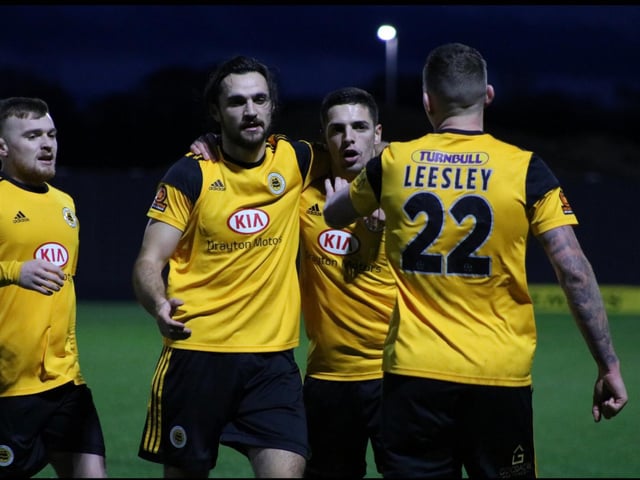 And is mobbed after goal number two. Photo: Oliver Atkin