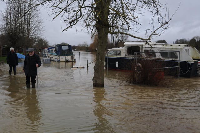 Checking on boats and properties after the River Nene burst its bank upstream of Orton Mere lock. Picture: David Lowndes