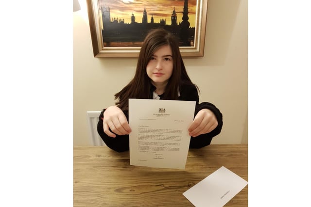 Emma Church, who is deaf and lives in Chipping Norton, sent a homemade see-through face mask to Prime Minister Boris Johnson, together with a letter asking him to introduce clear face masks across the country. The vast majority of face masks currently make lip-reading and the understanding of facial expressions much more difficult, leaving deaf people struggling to understand what is being said to them. 
Emma’s mum, Liz Church, said the following about getting a response from the Prime Minister: "When she opened the letter, the first words out of her mouth were 'Wow!' We read the letter together and there were tears in my eyes when I read, ‘Your attitude is brilliant and your hearing loss neither defines you nor will prevent you from achieving whatever you want in life.’"
(Photo: Chipping Norton, teenager Emma Church, holds the letter she received on behalf of the Prime Minister)