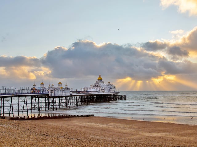 Eastbourne Pier bathed in sunlight with the sun streaming through the clouds. This shot was taken by Barry Davis, with a Canon 5d Mark iii. SUS-201230-102224001