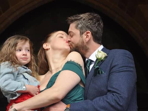 This little girl looks less than amused at her parents' wedding!