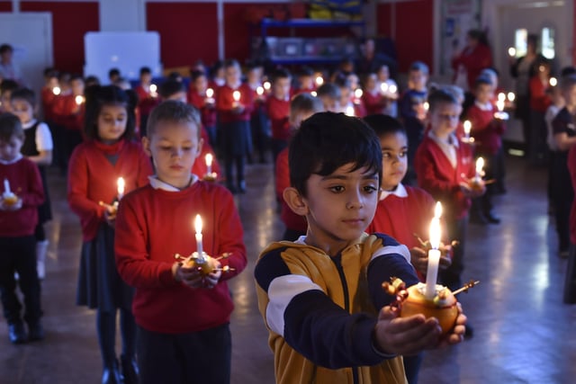 Year 2 pupils at Dogsthorpe Infants School taking part in their Christmas Christingle service this month.