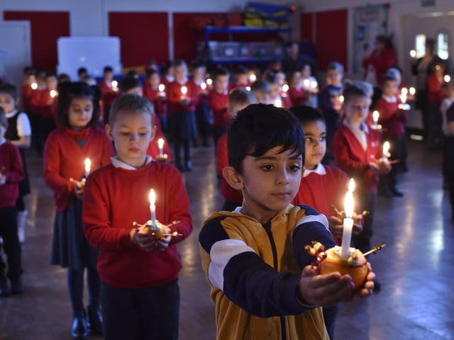Year 2 pupils at Dogsthorpe Infants School taking part in their Christmas Christingle service this month.