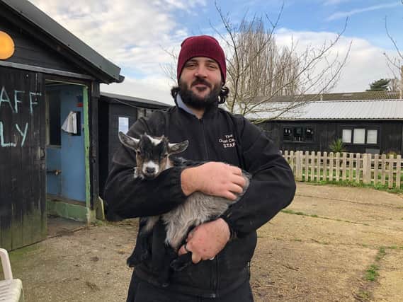 Head keeper Anthony with baby pygmy goat Buddy