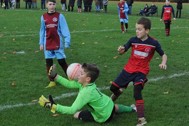 Action from an Under 12 Junior Alliance League football match between Thorpe Wood Rangers (purple) and Werringtom.