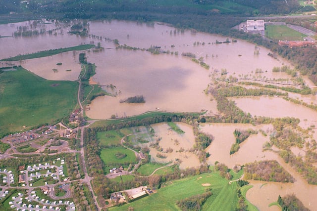 The recent flooding in and around 
Peterborough brought misery for many.  It will have also brought back memories of the ‘once in a lifetime’ flooding that occurred at Easter 1998. This picture shows the flooding at Ferry Meadows. Fortunately, the water didn’t reach the caravan park  (bottom left).