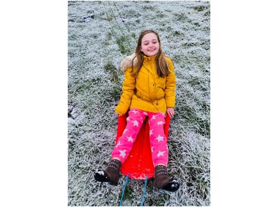 Sophie enjoys sledging in the snow in Enstone (photo from Kayleigh Jaycock)