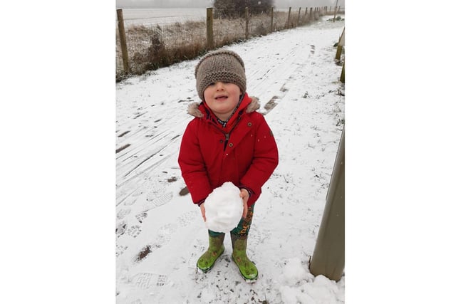 Archer, aged 3, makes a big snowball at Longford Park, Banbury (photo from Becky Fisher)