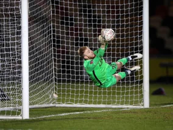 Brighton goalkeeper Jason Steele saves during the penalty shoot-out at Newport