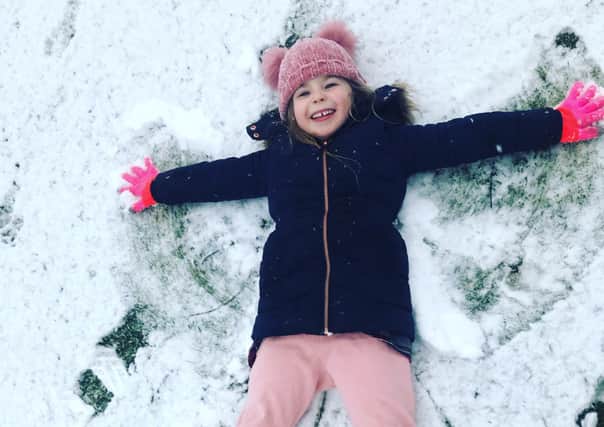 Esme Oxley-Waycot aged five making a snow angel after yesterday's snowfall.