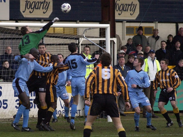 Substitute Dover keeper Phil Smith punches.