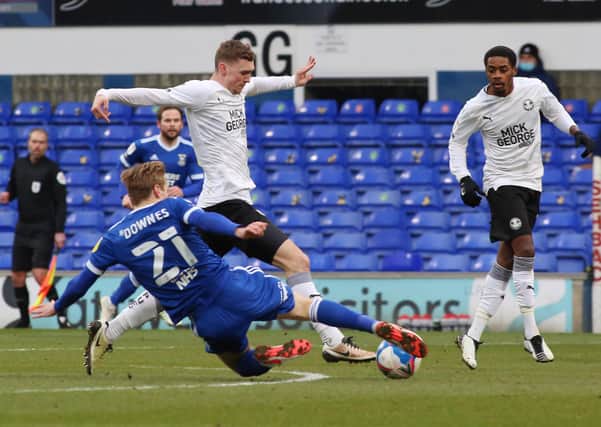 Jack Taylor of Peterborough United is tackled by Flynn Downes of Ipswich Town. Photo: Joe Dent/theposh.com.