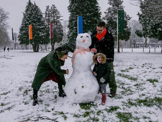 Mikey, Coco and Hannah Austin-Riley make a snowman in Becket's Park. Photo: Leila Coker