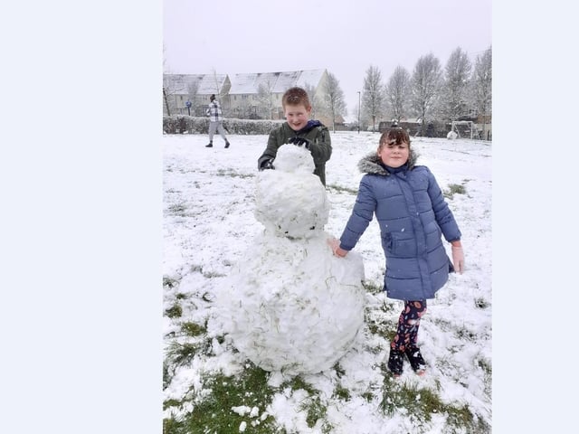 Lewis and Abigail Page have fun in the snow on Sugar Way.