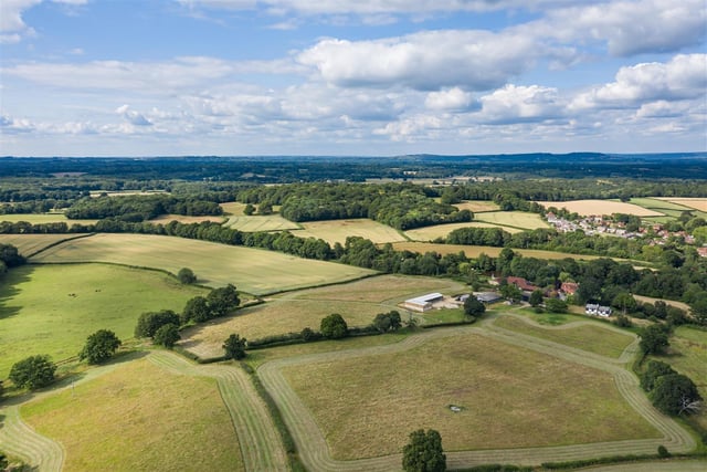 A rural 20-acre building plot with fields and paddock in a slightly elevated position with planning consent for a detached house, cottage and equestrian/agricultural complex. Price: £900,000.