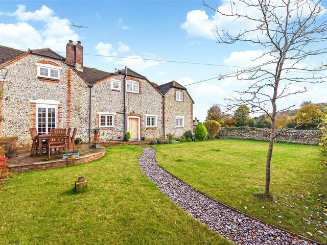 A beautifully presented attached period cottage in the heart of the South Downs National Park with downland views and two paddocks. Price: £850,000.