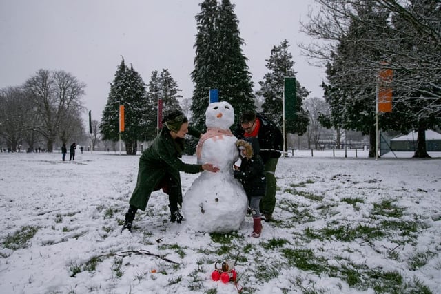 Mikey, Coco and Hannah Austin-Riley make a snowman in Becket's Park. Photo: Leila Coker