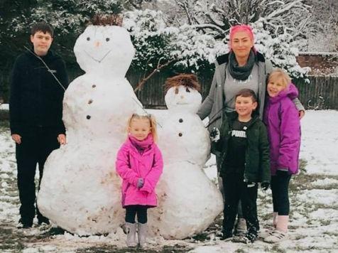 The Bufton family with their snowmen.
