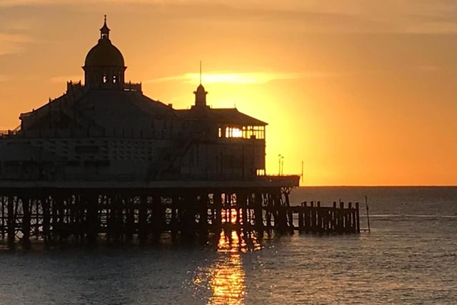 Sunrise at Eastbourne pier by Mike Carrington. SUS-210127-145926001