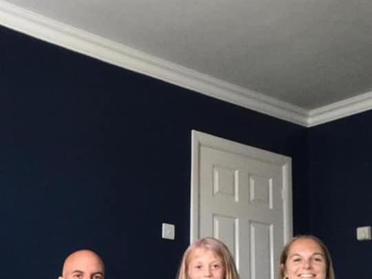 A lovely family photo of the Burnetts with Benji