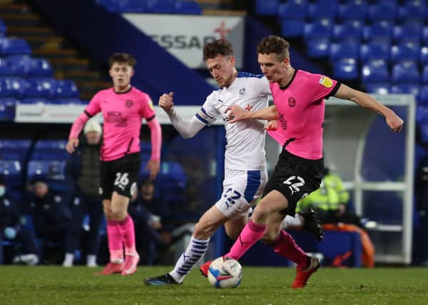 Ethan Hamilton of Peterborough United battles with Paul Lewis of Tranmere Rovers. Photo: Joe Dent/theposh.com.