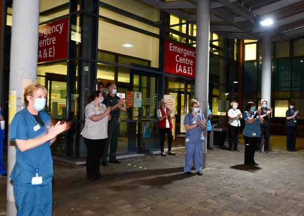 Staff applaud in tribute to Captain Sir Tom Moore outside Peterborough City Hospital. Picture: David Lowndes