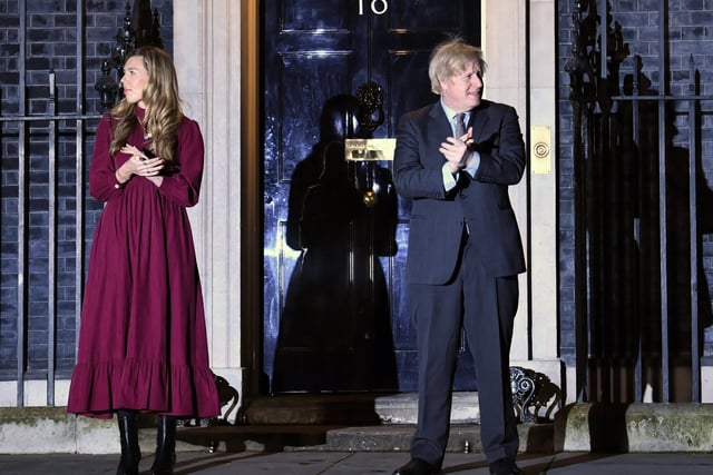 Prime Minister Boris Johnson and his partner Carrie Symonds stand outside 10 Downing Street, London, to join in with a nationwide clap in honour of Captain Sir Tom Moore. Picture PA Wire/PA Images.