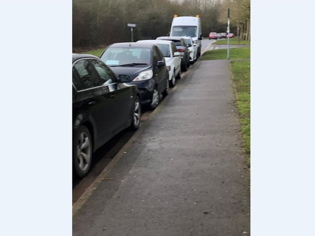 Cars parked outside of the vaccination centre at Orton Wistow.