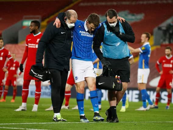 Brighton's Solly March sustained a serious knee injury during the 1-0 victory at Champions Liverpool