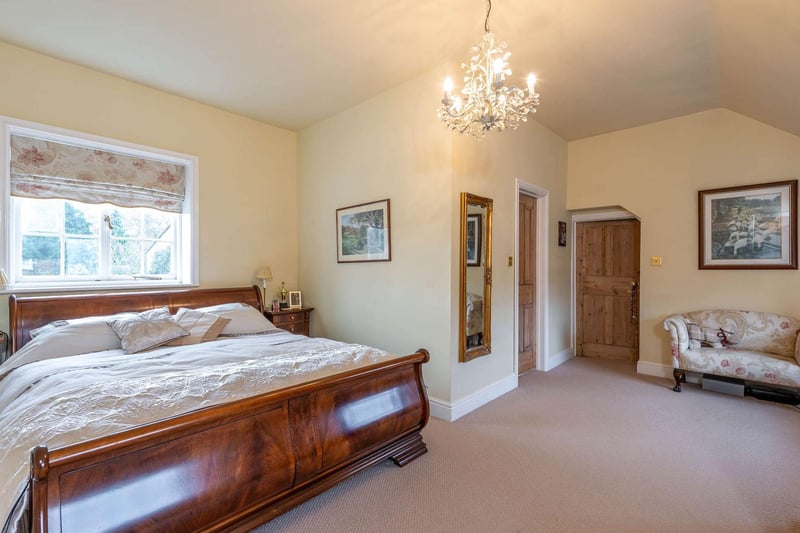 The large double room has a walk in dressing room with fitted units and a shower room en suite. This bedroom also benefits from an additional room off which lends itself to be used as dressing room, office or nursery.