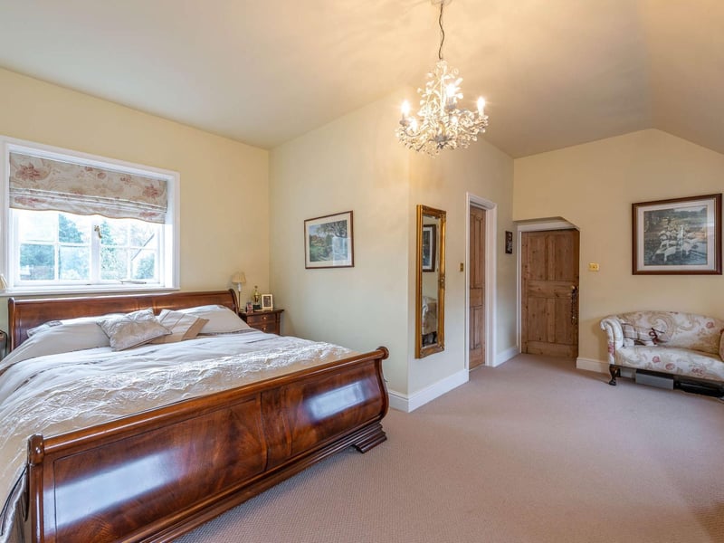 The large double room has a walk in dressing room with fitted units and a shower room en suite. This bedroom also benefits from an additional room off which lends itself to be used as dressing room, office or nursery.