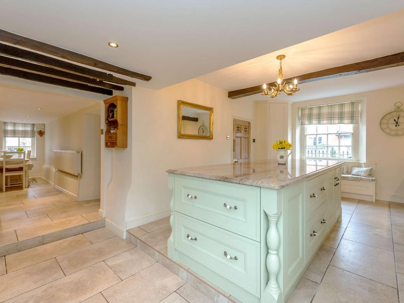 The kitchen breakfast room has a bespoke handmade kitchen by Woodworks. A central island with integrated double drawer fridge and breakfast bar. Integrated appliances and a Rangemaster 110 cooker range. The room has a breakfast area with space for a table and chairs and a window seat.