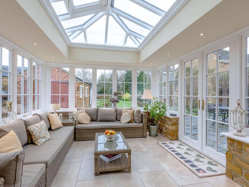 The airy conservatory provides lovely views of the landscaped gardens