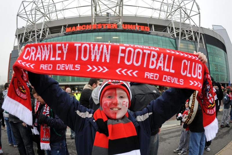A young Reds fan outside the ground before the game