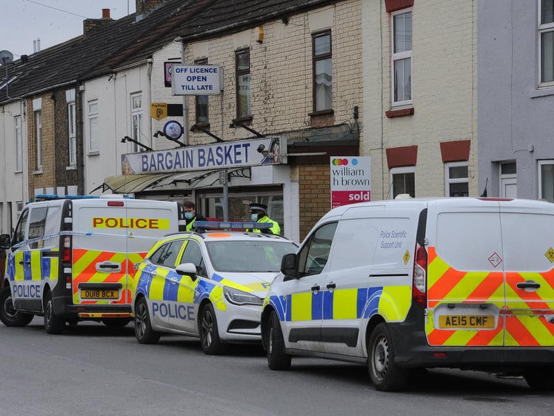 Police vehicles in Fletton High Street.