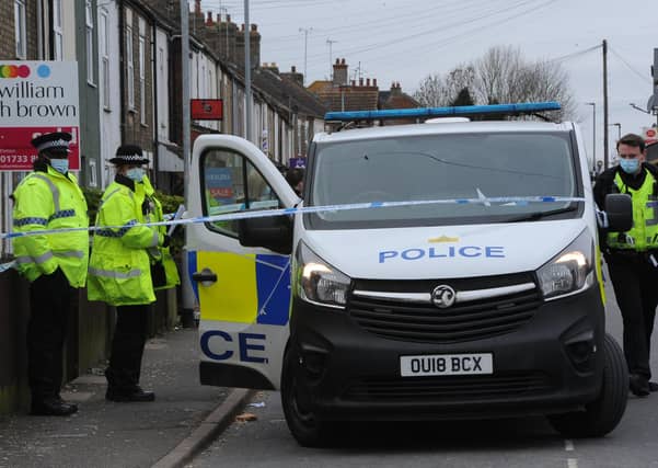 Police have taped off an area outside a house on Fletton High Stree.