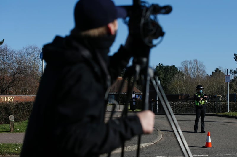 A member of the press films a police officer outside Bedford Crematorium ahead of Captain Sir Tom Moore's private funeral (Photo by Hollie Adams/Getty Images)