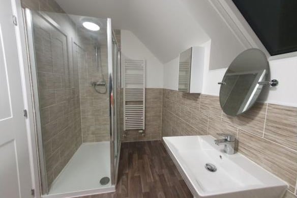 The en-suite bathroom accessible from the master bedroom has a shower, heated towel rail, wash basin and WC.