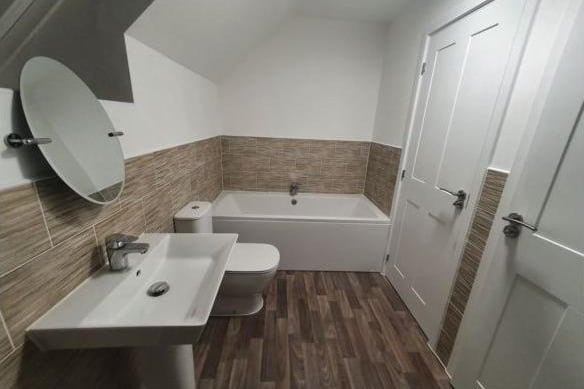 The family bathroom contains a standalone bath, WC and washing basin.