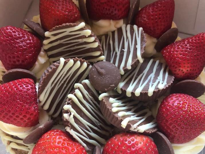 'Cookie Mama' bakes both cookies and layered cookie cakes with buttercream filling. The cookie cake pictured is topped with strawberries, Reece's peanut butter cups and caramel buttons - scrumptious! Visit Cookie Mama's Facebook page for more information.